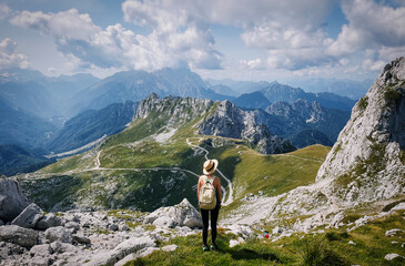 Young girl enjoying beauty of nature looking at mountains in europe. Adventure travel in Slovenia....