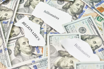 Billionaires income tax. Pile of us dollar banknotes and pieces of paper with Billionaires text. Billionaires income tax proposed in US Senat