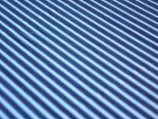 Blue corrugated surface with diagonal stripes. High quality photo