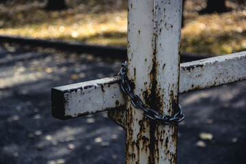 Rusty barrier with chain. Closed barrier