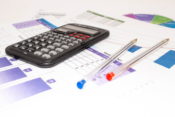 Accounting data, charts, calculator and pen. Many charts and gra