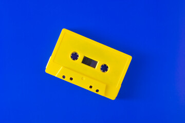 yellow gold vintage audio cassette tape recorder on dark blue background
