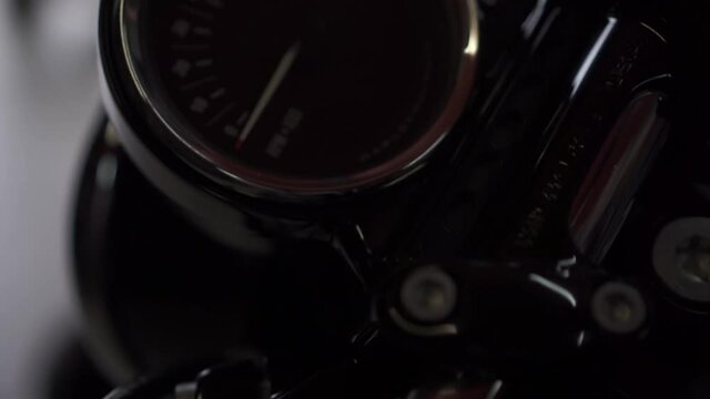Close-up of the gas grip of the motorcycle. Footage. Motorcycle dashboard with tachometer