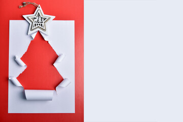 Christmas tree made of paper on a red background