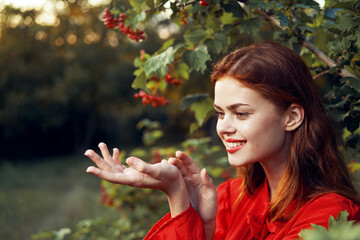 pretty woman in red dress green leaves berries summer