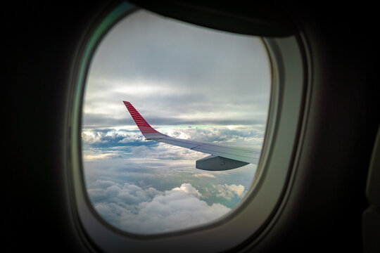 View of the sunset from the window of a commercial airliner as it flies overhead