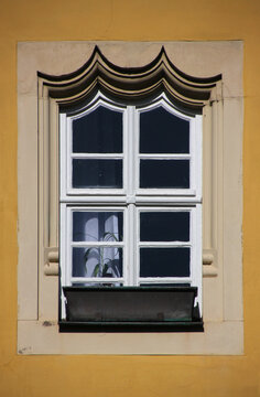 Renaissance window frame with a twice inflexed arch at the Beguines House facade in the old town of Kitzingen in Germany