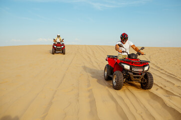 Two racers coming down from the dunes on atv © Nomad_Soul