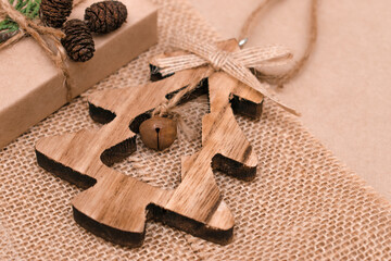 Festive decorations in eco-style.Toy wooden Christmas tree on a beige background.Christmas,New Year and eco-friendly concept.