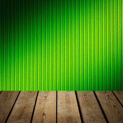 The background is blank wooden boards and a textured striped wall with gradient lighting and...