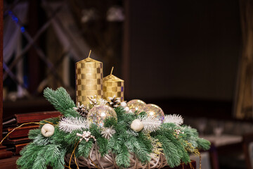 Christmas golden candles with a coniferous twig