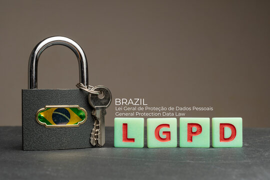LGPD (brazilian data protection law) concept: lock with brazil flag on a table with some plastic tiles with the acronym of the Brazilian data protection law (Lei Geral de Proteção de Dados Pessoais).