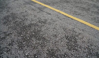 Fototapeta premium Close-up to asphalt Road and yellow line background texture black construction the industry Lane Blacktop