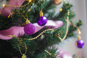 New Year. Christmas tree with golden balls and garland.
