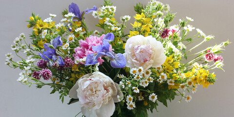 lush summer bouquet with peonies irises daisies