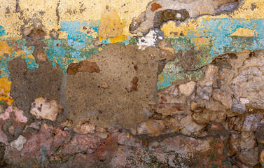 Colorful painted wall texture with old stones and plaster