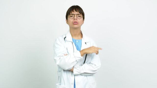 Young woman with nurse uniform doing silence gesture over isolated background