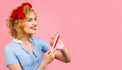 Smiling Woman polishing fingernails with nail file. Manicure. Nails care. Copy space for Advertising beauty salon.