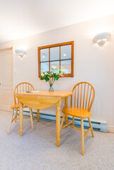 Table with flowers and two chairs. Interior design of a luxury living room.