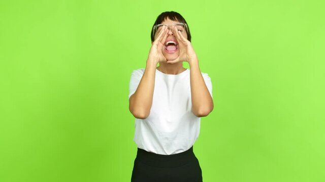 Young woman shouting and announcing something over isolated background. Green screen chroma key