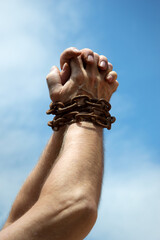 Chained hands praying for help