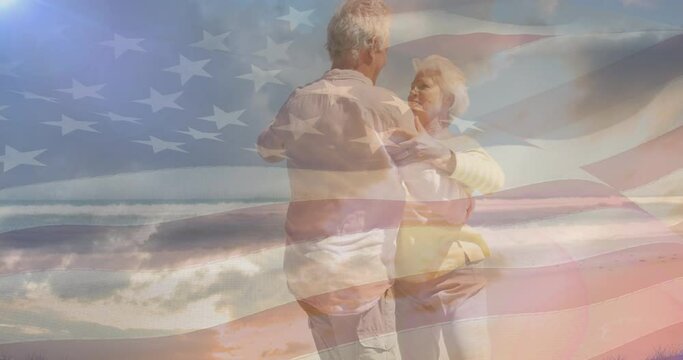Animation of happy senior caucasian couple dancing on beach over flag of united states of america