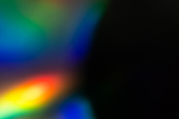 Blur colorful rainbow crystal light leaks on black background. Defocused abstract multicolored...
