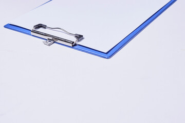 White paper on the clipboard. Copy space