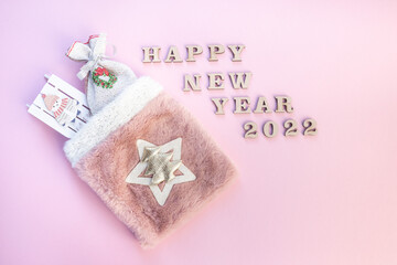 Christmas bag with gifts on a pink background
