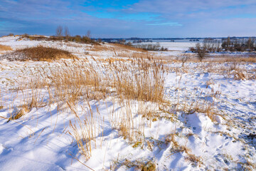 Snowy landscape with hills and meadows in Buytenpark Zoetermeer, the Netherlands