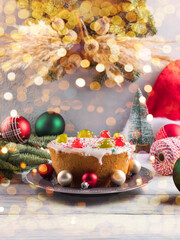 Italian christmas cake with sweet decor and xmas ornament, lights