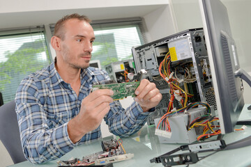 Fototapeta na wymiar a man is fixing computer