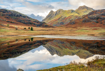 Reflections in Blea Tarn in the Langdales hanging Valley in the Lake District, Cumbria, England © dvlcom