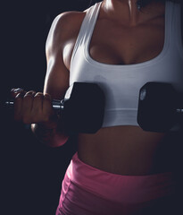 Cross training. Young woman exercising at the gym