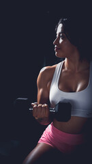 Cross training. Young woman exercising at the gym