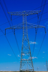 Electric power transmission lines at sky background, autumn field