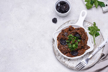 Hot stewed meat with prunes