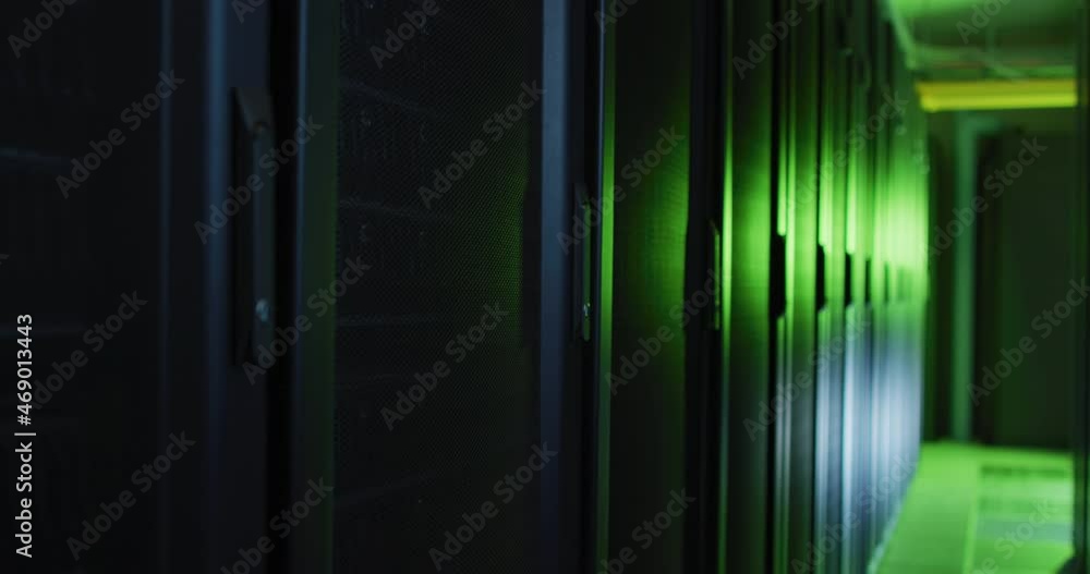 Poster green control lights reflected on computer servers in tech room