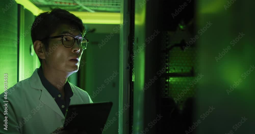 Aufkleber asian male it technician in lab coat using tablet checking computer server