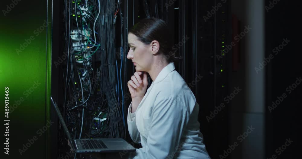 Aufkleber caucasian female it technician in lab coat using laptop checking computer server
