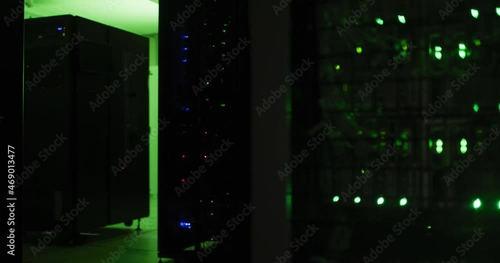 Poster close up of green control lights flashing on computer servers in tech room