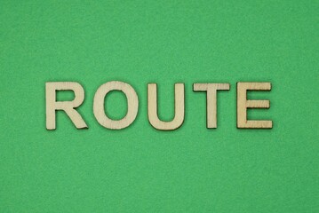 gray word route from small wooden letters on a green table