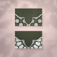 Presentable business card in dark green color with vintage white ornaments for your contacts.