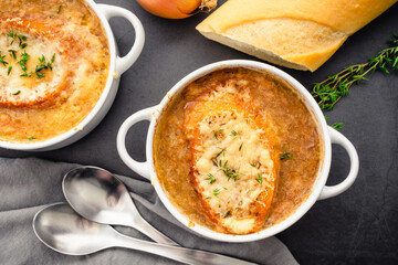 Bowls of French Onion Soup With Toasted Bread and Melted Cheese: Bowls of French onion soup garnished with fresh thyme