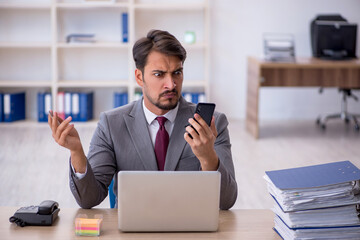 Young male employee working in the office