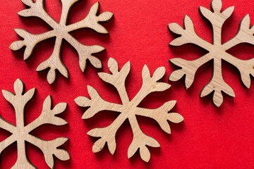 wooden christmas snowflakes on red paper
