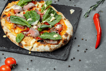 Meat Italian pizza with roast beef, steak slices, melted cheese, with olive slices and cheddar cheese. Close up, macro. Pizza time concept