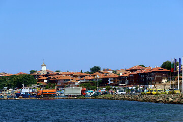 Obraz premium Coastal view of Nesebar city houses and embankment. Nesebar Bulgaria. Ancient town on the Black Sea coast, UNESCO