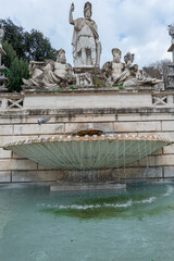 Fototapeta na wymiar The Fontana del Nettuno (Fountain of Neptune) is a fountain located in the Piazza del Popolo. It was built in the 1822 by Giovanni Ceccarini. The Fontana del Nettuno shows Neptune with his Trident.
