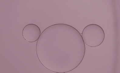 Abstract oil droplets on water surface creating bubble and circle shape pink lavender  light effects background.	